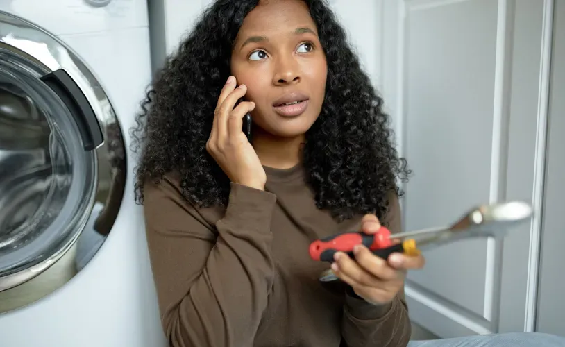 woman-with-tools-calling-repair-service-laundry